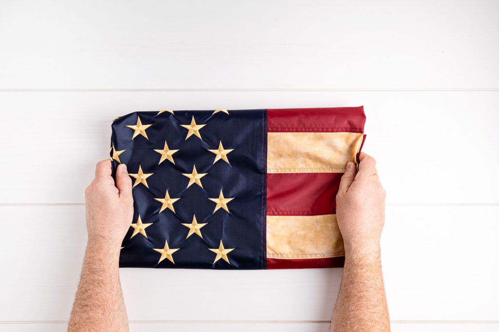 Traditional cotton American flag displayed in a ceremonial setting.